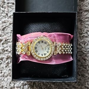 Gold embellished watch with Roman numerals with box